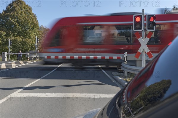 Passing train at a level crossing with barriers