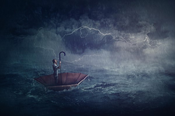 Person sailing alone the ocean on an umbrella boat