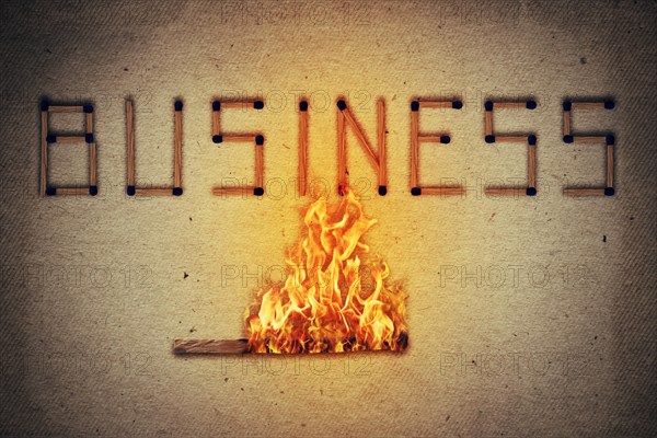 Burning match setting fire to its neighbors in arranged in shape of business word