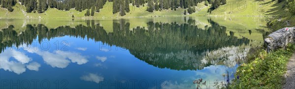 Reflections in the Oberstockesee lake on the Stockhorn