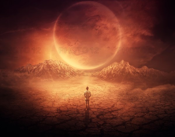 Surreal background as a young boy walks on another planet with dry and cracked ground
