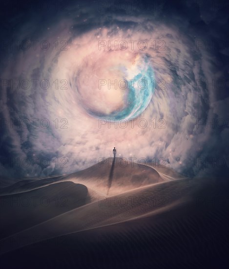 Person silhouette on the top of a dune in a desert looking at the mysterious phenomena in the sky