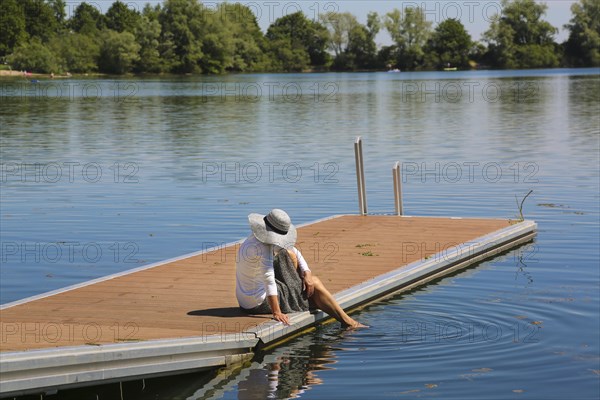 Woman with sun hat on jetty