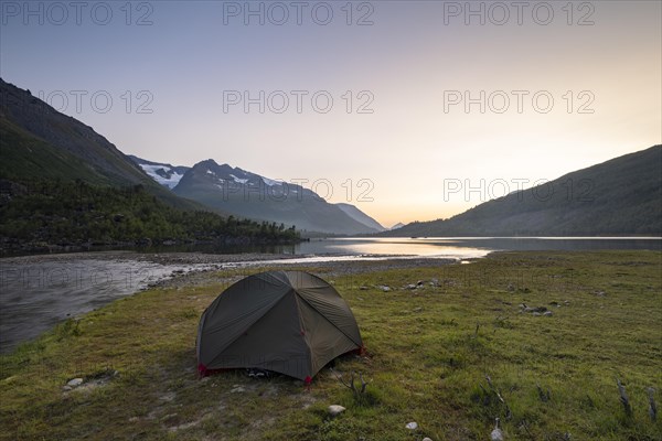 Tent by the lake Innerdalsvatna in the evening mood