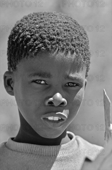 South African boy looks sceptically at the camera