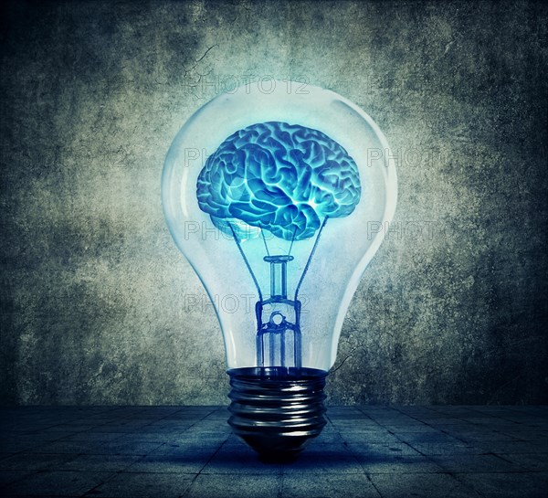 Human brain glowing inside a light bulb