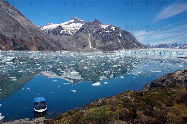 Small boat in the calm waters of a fjord