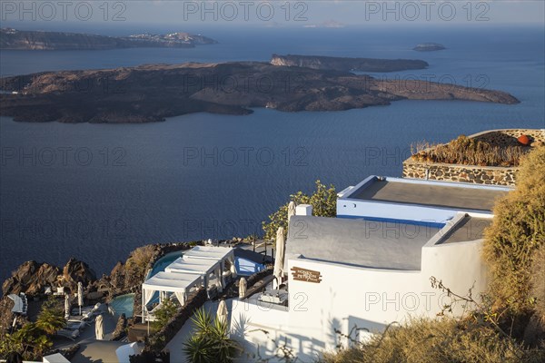 Terrace with pool of a small hotel with a view over the blue sea