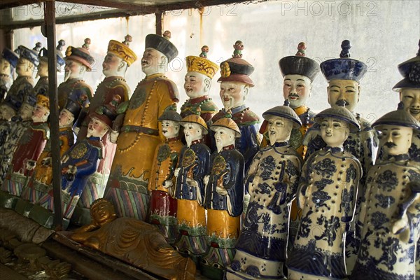Emperor figures of coloured porcelain in antique shop