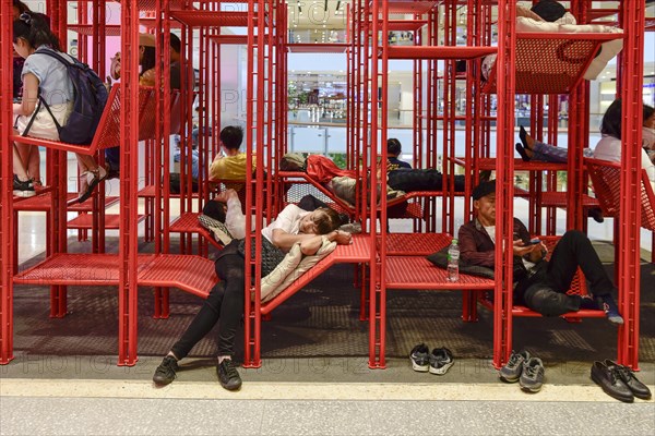 Red iron rack with seating and lounging area for customers to rest