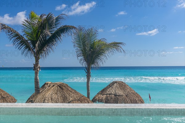 Swimming pool over the turquoise waters of Cancun