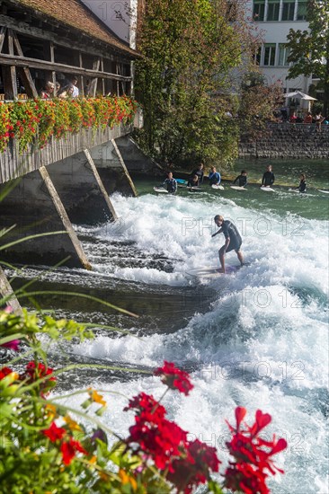 Surfer under the Untere Schleuse bridge surfing on the Aare