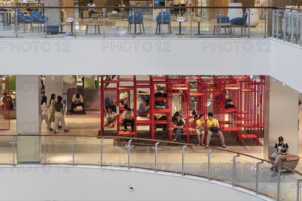 Red iron rack with seating and lounging area for customers to rest