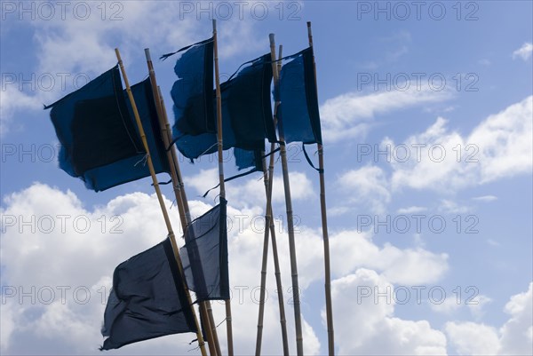 Flags and pennants to mark nets and fish traps laid out in the harbour of Hvide Sande