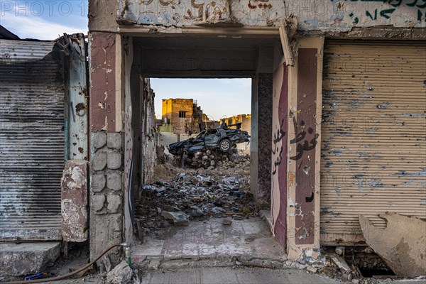 Demolished car in a destroyed house from ISIS