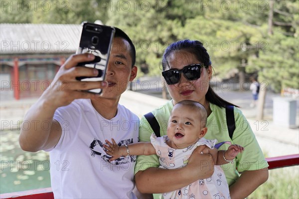 Chinese couple with child on a trip to the Summer Palace