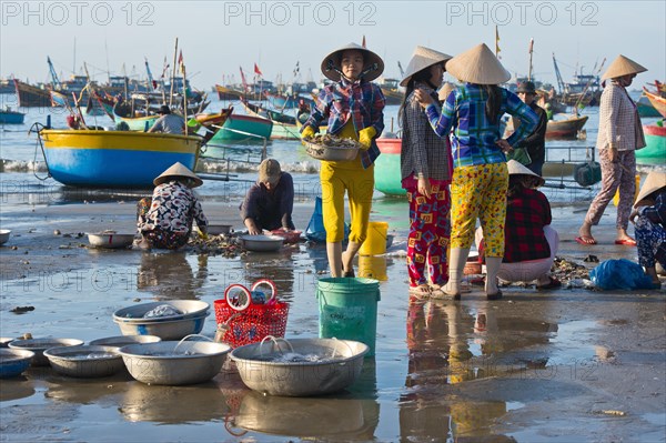 Fishermen on the beach with freshly caught fish and seafood
