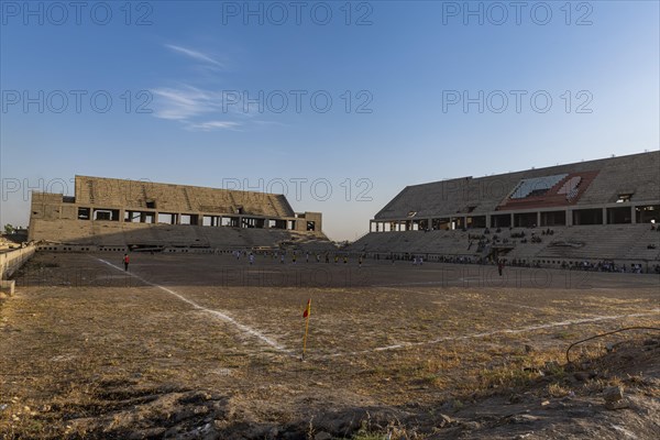 Soccer game in the ruins of the soccer stadium of Mosul