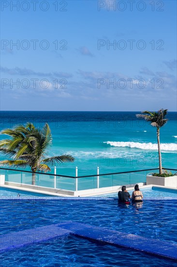 Swimming pool over the turquoise waters of Cancun