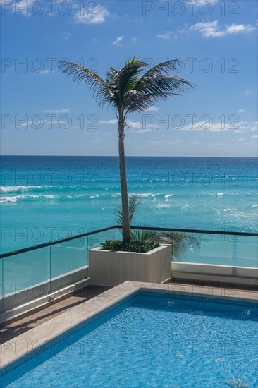 Swimming pool over the turquoise waters of Cancun