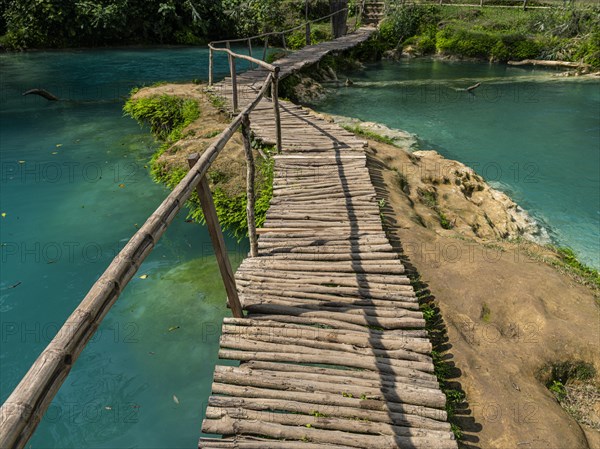 Wooden bridge crossing the turquoise water of the Minas viejas waterfalls