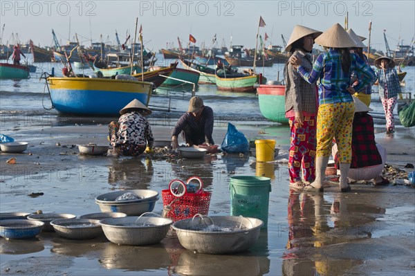 Fishermen on the beach with freshly caught fish and seafood