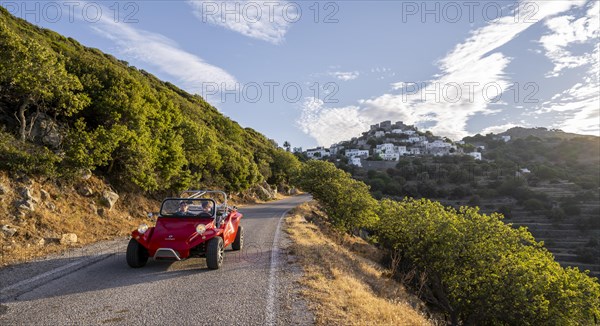 Red beach buggy on street in the evening sun