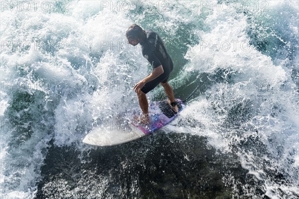 Surfer under the Untere Schleuse bridge surfing on the Aare