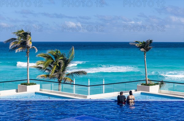 Swimming pool over the turquoise waters of Cancun