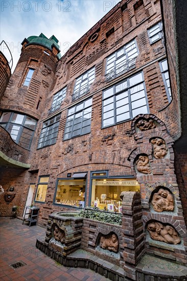 House of the Seven Lazy People with Seven Lazy People Fountain in Boettcherstrasse in the Old Town of Bremen