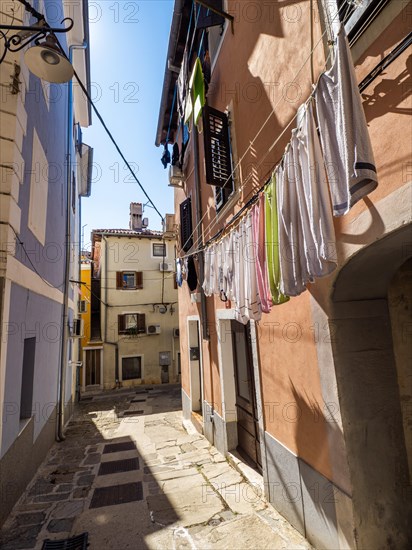 Laundry hanging to dry in a narrow alleyway of the old town of Izola