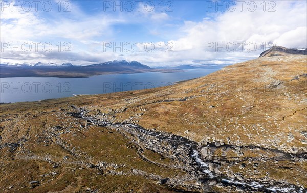 Autumnal fell landscape with a view of the lake Akkajaure and the mountain range Akka