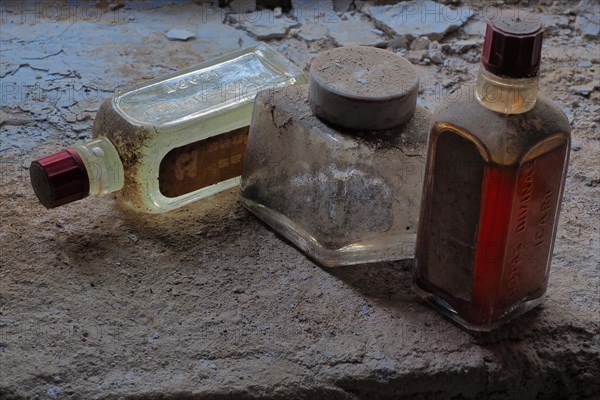 Old dusty bottles with patina on the floor