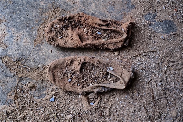 Pair of dilapidated canvas shoes from above