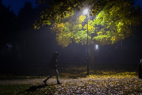 A woman walks through a lonely park in Markt Swabia