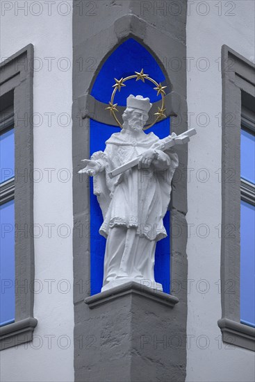 Sculpture of St. Nepomuk in a niche of a corner house