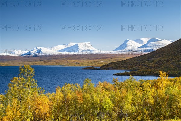 Snowy mountain group Lapporten and lake Tornetraesk