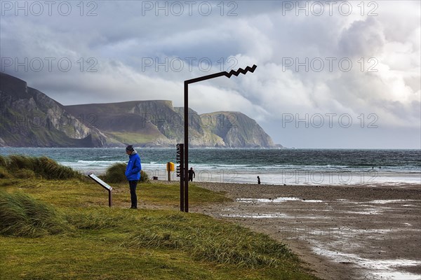 Person reading information board at Keel Strand viewpoint