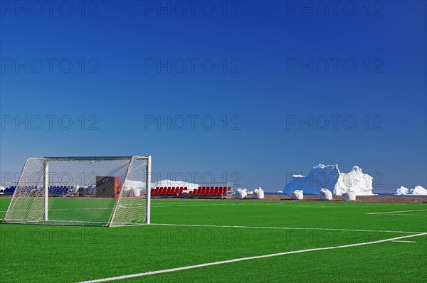 Football ball with goals in front of icebergs