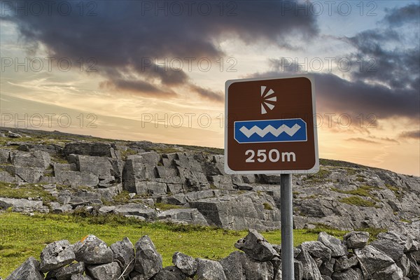 Wavy logo on a sign marks viewpoint in karst landscape