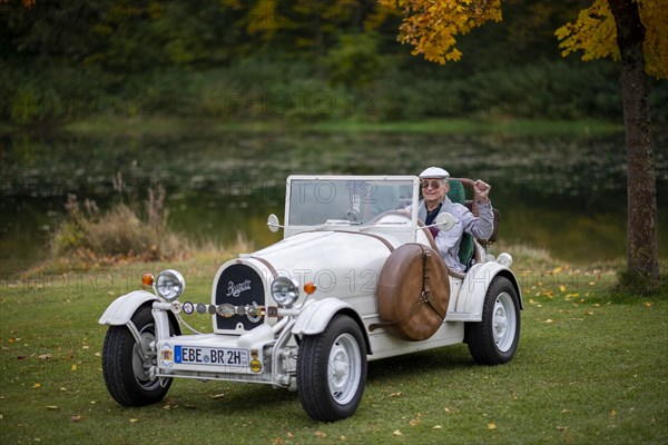 An elderly gentleman sitting in his replica of a 1923 Bugatti 35 B