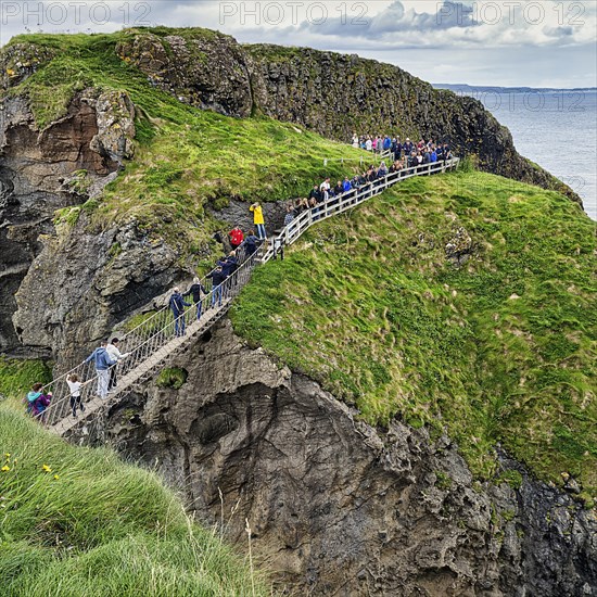 Narrow suspension bridge for pedestrians on rocky coast