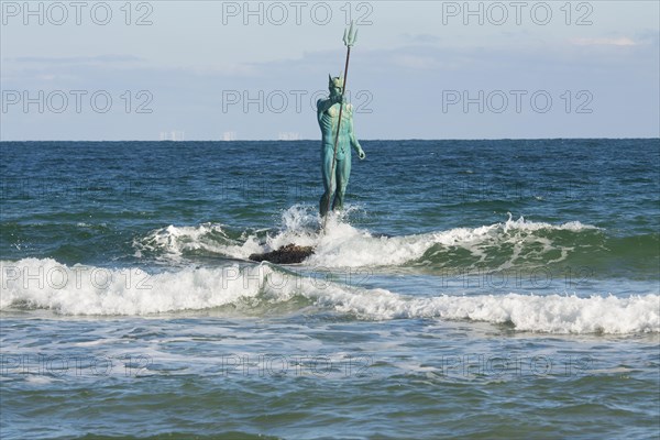 Sculpture of Neptune in sea near the beach