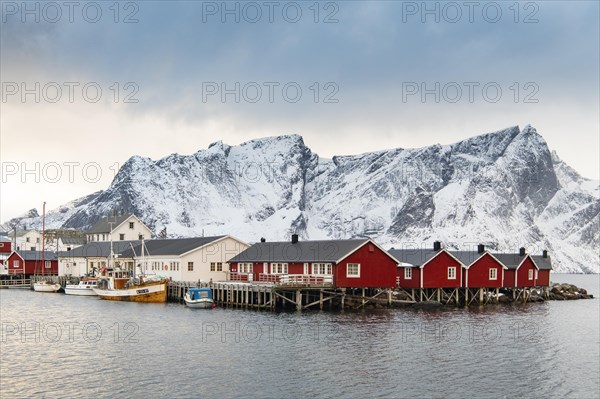 Red boathouses in winter harbour