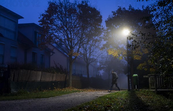 A woman walks through a lonely park in Markt Swabia