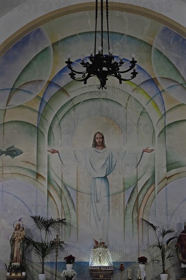 Mural of Jesus with outstretched arms in church