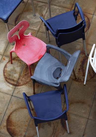 Jumbled up colourful plastic chairs