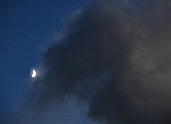 Evening sky with clouds and half moon