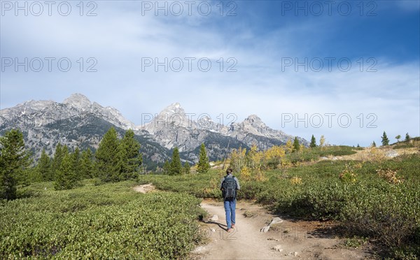 Young man on the hiking trail to Taggart Lake