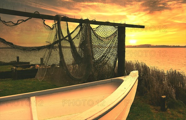 Fishing nets and fishing boat in the sunset